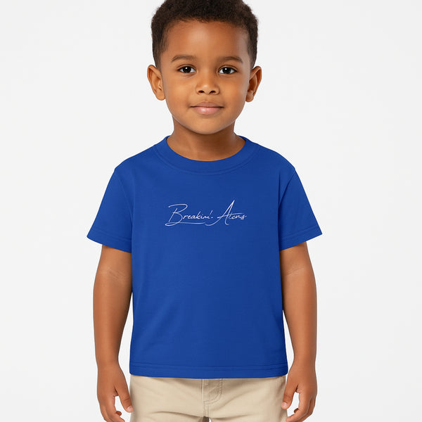 Child wearing Breakin' Atoms "The Little Voyager Tee," a kids’ graphic t-shirt featuring a whimsical space travel design that celebrates curiosity, creativity, and big dreams.
