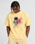 Black male model wearing Breakin’ Atoms Into Another World graphic tee in Butter with matching pants thumbnail 1
