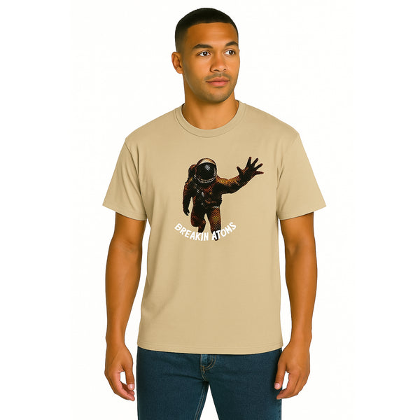 Model wearing Breakin' Atoms "Astral Expedition T-Shirt" — a cosmic-themed short sleeve tee with futuristic typography and space exploration graphics, symbolizing adventure, curiosity, and bold style.