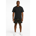 Model wearing Breakin' Atoms "Aurora Drops Shorts," featuring a vibrant, colorful drip-print inspired by the aurora borealis — a statement streetwear piece with cosmic energy and movement. thumbnail 1