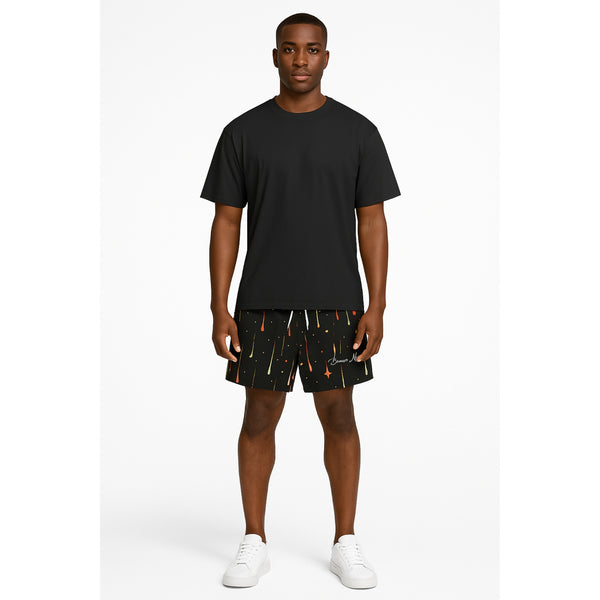 Model wearing Breakin' Atoms "Aurora Drops Shorts," featuring a vibrant, colorful drip-print inspired by the aurora borealis — a statement streetwear piece with cosmic energy and movement.