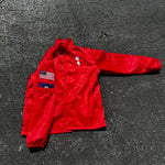 Breakin' Atoms Coach's Jacket in red satin, laid flat on asphalt. Features custom flag patch, American flag, and Getaway Man logo thumbnail 2