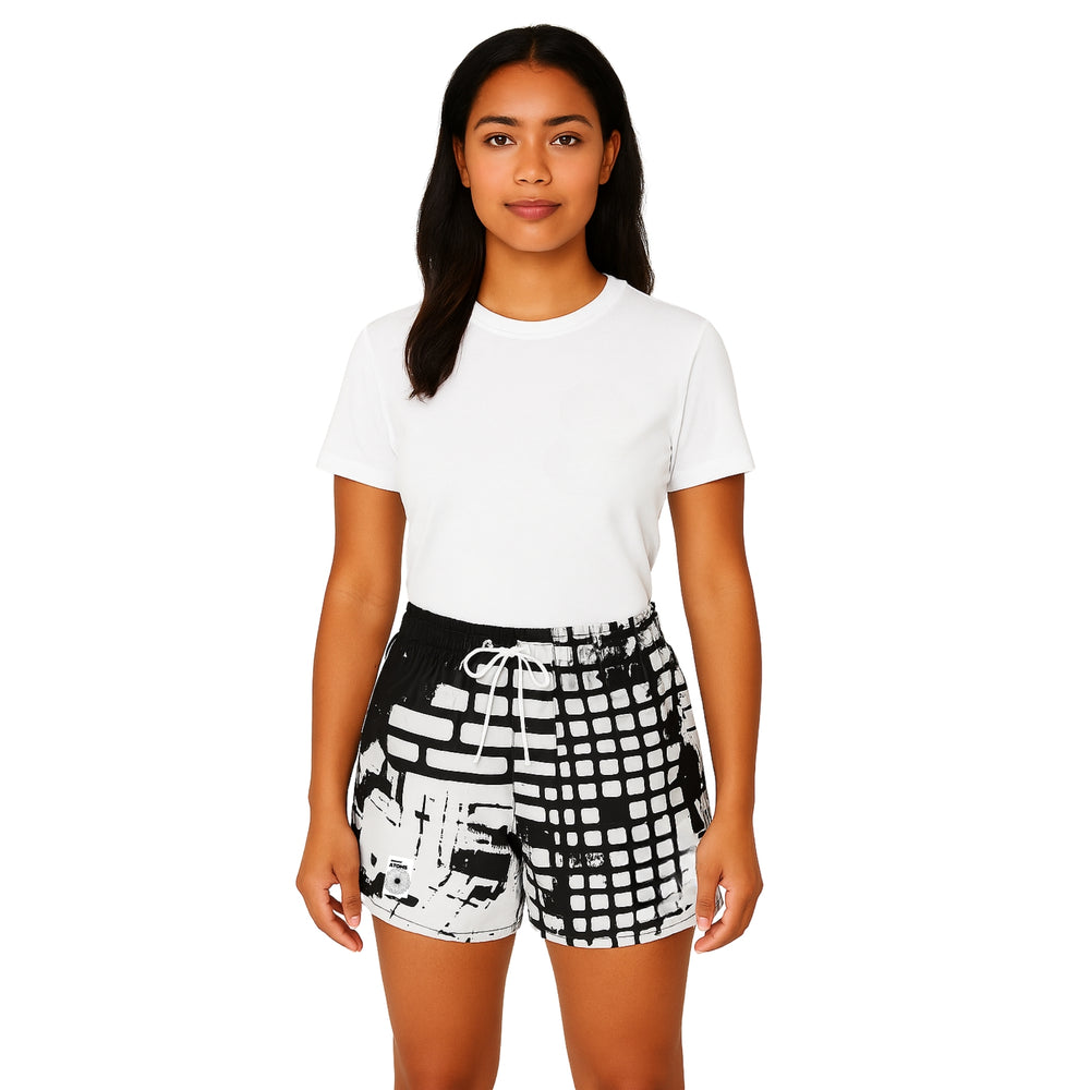 Female model in Breakin' Atoms "Dragon Lady Shorts," styled with monochrome abstract design, mid-thigh length, and relaxed fit — a unisex summer short perfect for expressive everyday outfits — Breakin Atoms premium streetwear