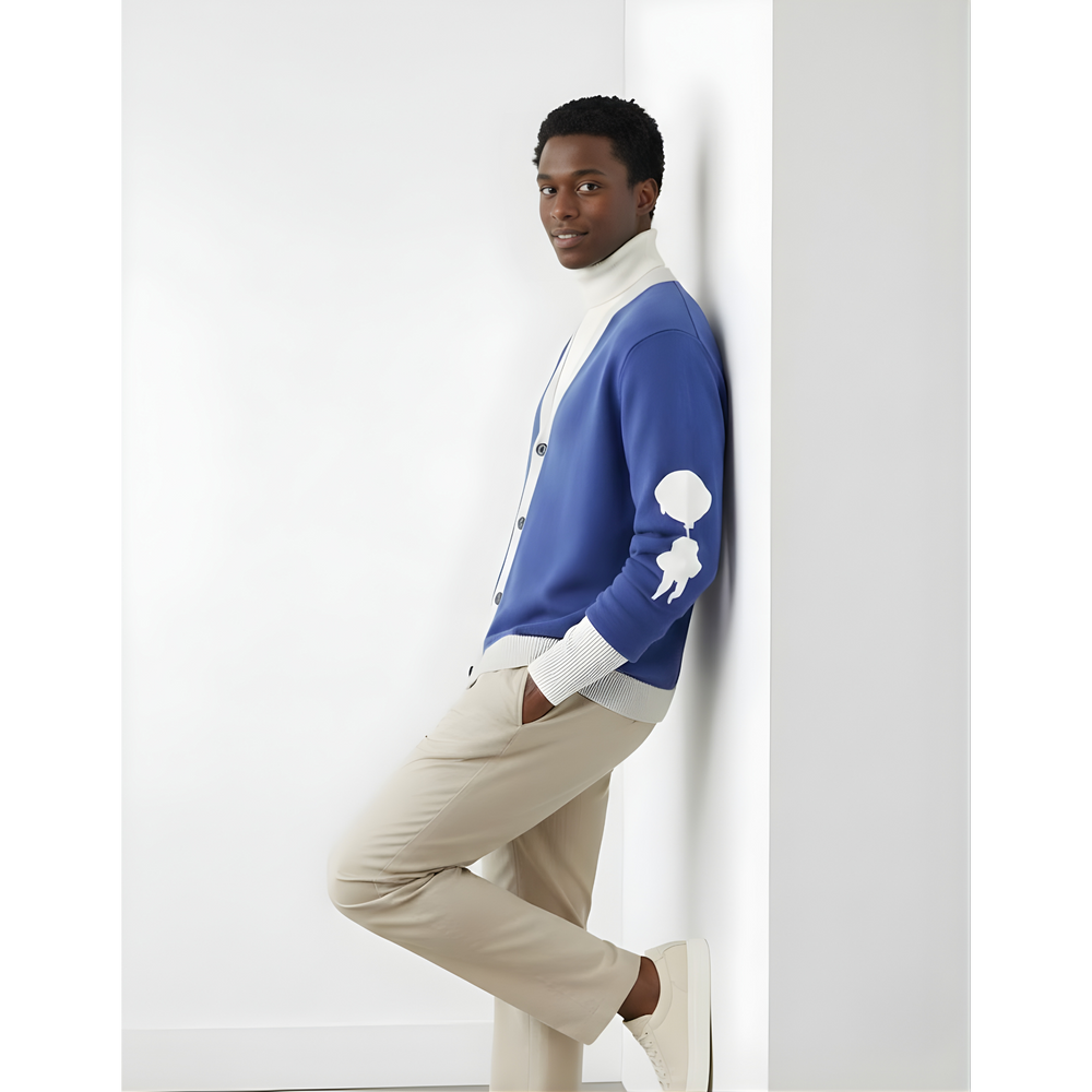“Breakin’ Atoms L Cloud Thread Cardigan in blue with cream ribbed collar, cuffs, and hem, button-front knit cardigan featuring a white sleeve logo graphic, shown on model in side profile.” — Breakin Atoms premium streetwear