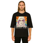 Model wearing Breakin' Atoms "Liberty Spectra T-Shirt," featuring a bold and artistic reimagining of the Statue of Liberty in vibrant tones — blending national symbolism with modern streetwear flair. thumbnail 1
