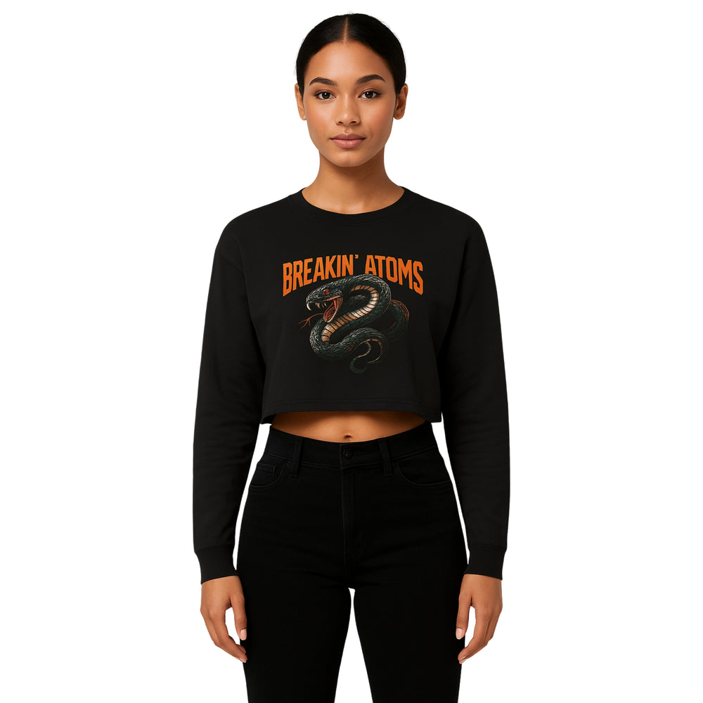 Model wearing Breakin’ Atoms "Serpent Strike Crop Top" — a bold, fitted cropped tee featuring a striking serpent graphic and clean typography, blending mystique, power, and sharp streetwear style. — Breakin Atoms premium streetwear