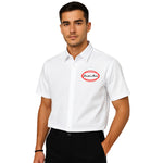 Model wearing Breakin' Atoms "Work Shirt," a structured short sleeve button-up inspired by classic utility and mechanic shirts, featuring durable fabric and embroidered logo details — built for function and streetwear form. thumbnail 1