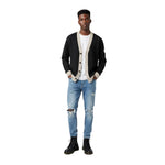 Model in a relaxed stance wearing the Breakin’ Atoms Cloud Thread Cardigan, styled with light denim and boots. thumbnail 3