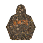 Back view of a Breakin’ Atoms camouflage hoodie covered in a fall leaf forest pattern. Across the back, a large orange Breakin’ Atoms logo in sharp gothic lettering stands out against the camo background. thumbnail 2