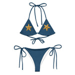 Model wearing Ostra bikini set, front view, featuring blue triangle top with embroidered starfish and adjustable string-tie bottoms. thumbnail 2