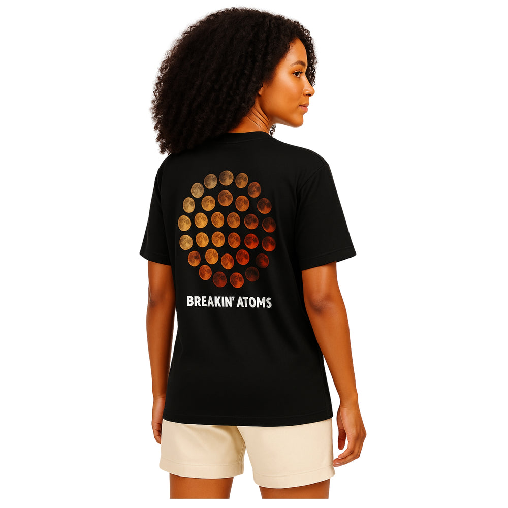 Woman wearing Phases by Breakin' Atoms black t-shirt with lunar cycle graphic and white logo on back — Breakin Atoms premium streetwear